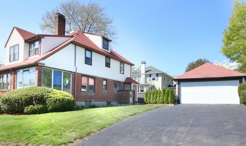 144 Lovell Road Watertown, MA 02472 - Photo 24 of 25 a front view of a house with a garden and plants