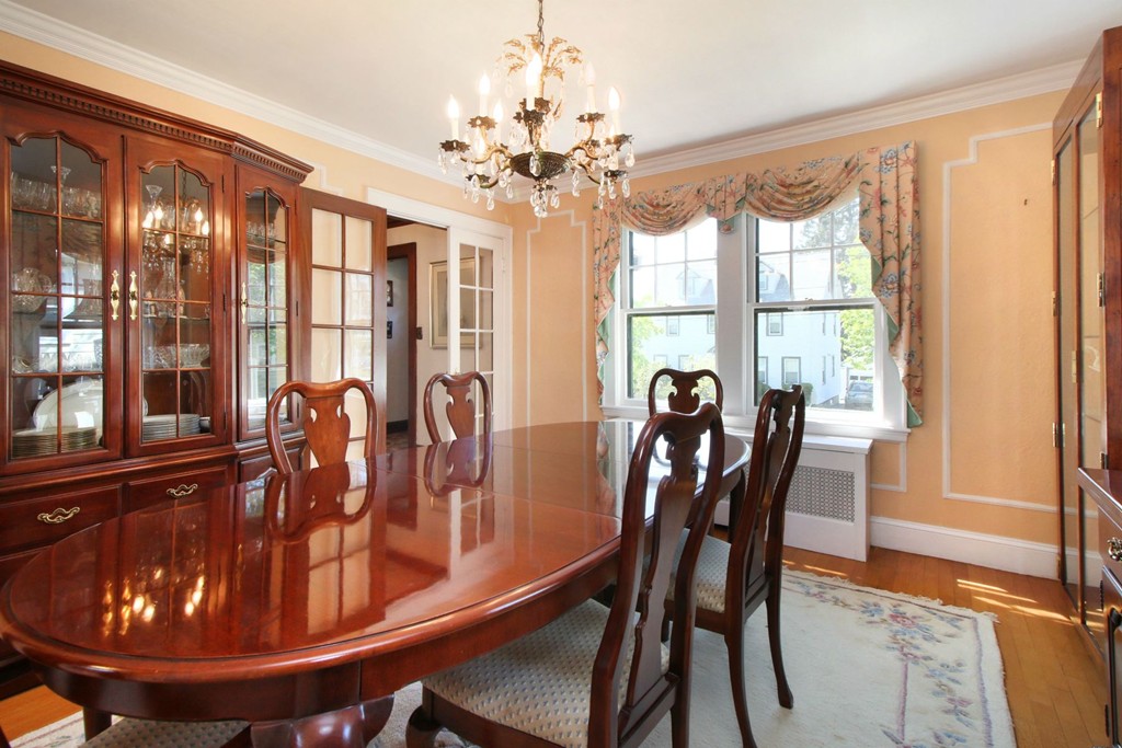 144 Lovell Road Watertown, MA 02472 - Photo 3 of 25 a dining room with furniture a chandelier and wooden floor