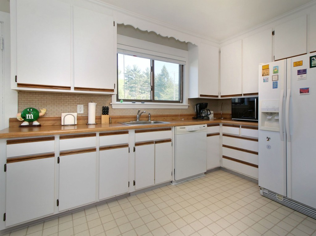 144 Lovell Road Watertown, MA 02472 - Photo 7 of 25 a kitchen with white cabinets and white appliances