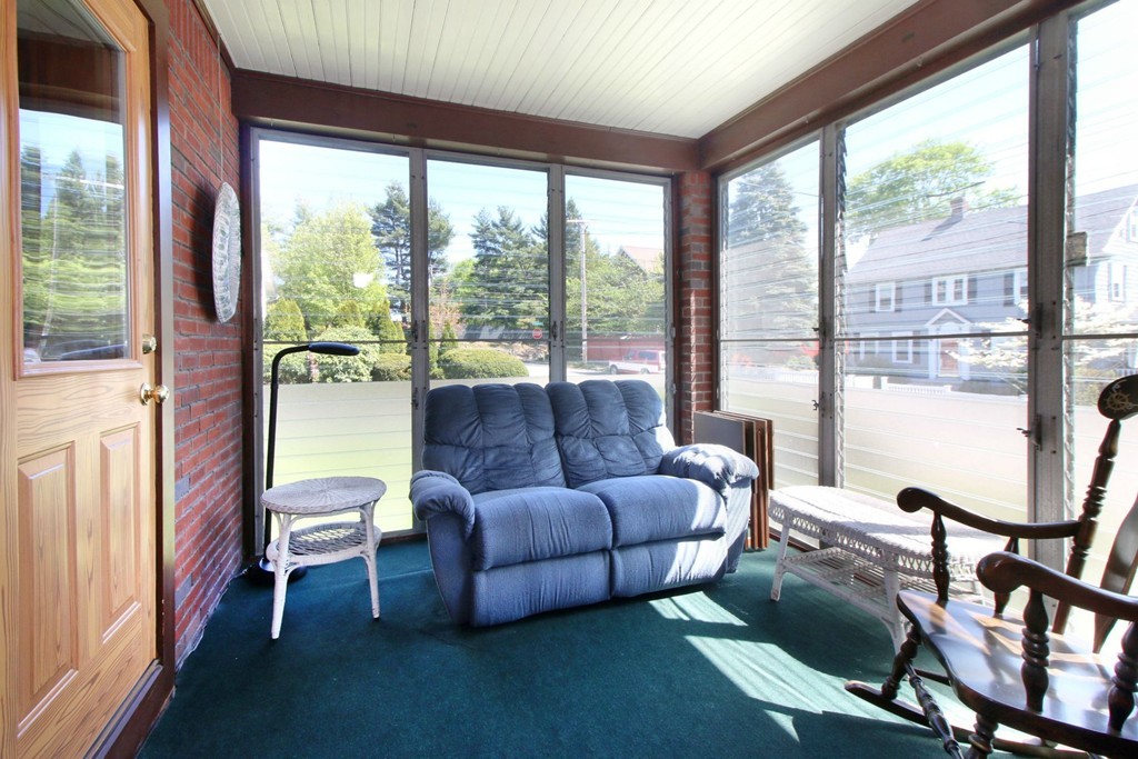 144 Lovell Road Watertown, MA 02472 - Photo 8 of 25 a living room with furniture and a floor to ceiling window