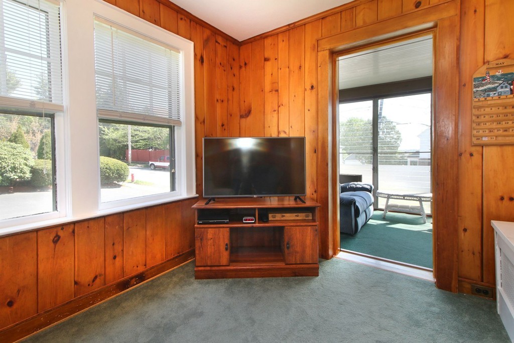 144 Lovell Road Watertown, MA 02472 - Photo 9 of 25 a living room with furniture and a flat screen tv