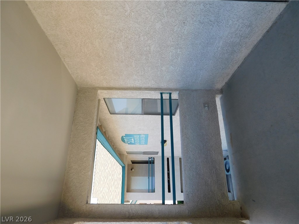 5221 South Lindell Road, Unit 202 Las Vegas, NV 89118 - Photo 6 of 28 A well-lit, open-air walkway connects multiple residences within this modern complex.