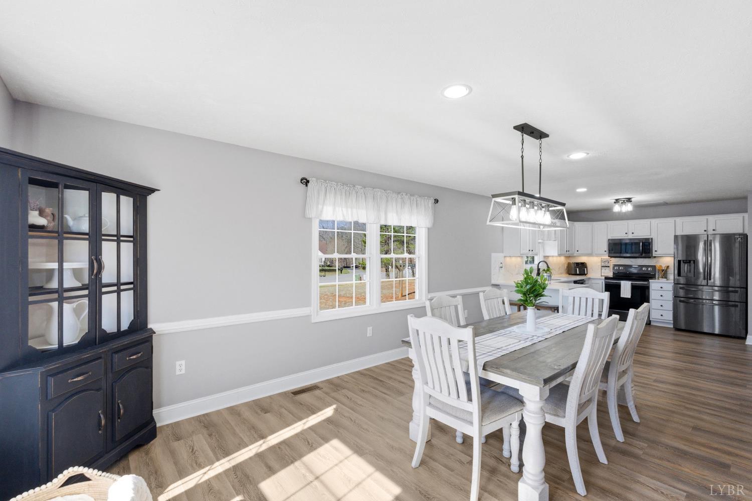 181 Armistead Lane Rustburg, VA 24588 - Photo 15 of 52 a view of a dining room with furniture window and wooden floor