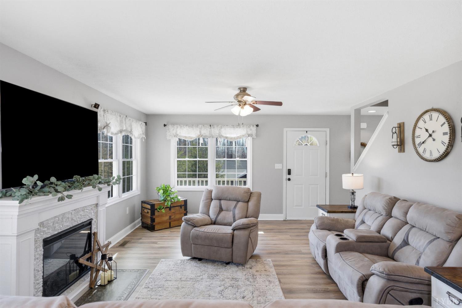 181 Armistead Lane Rustburg, VA 24588 - Photo 2 of 52 a living room with furniture a flat screen tv and a large window