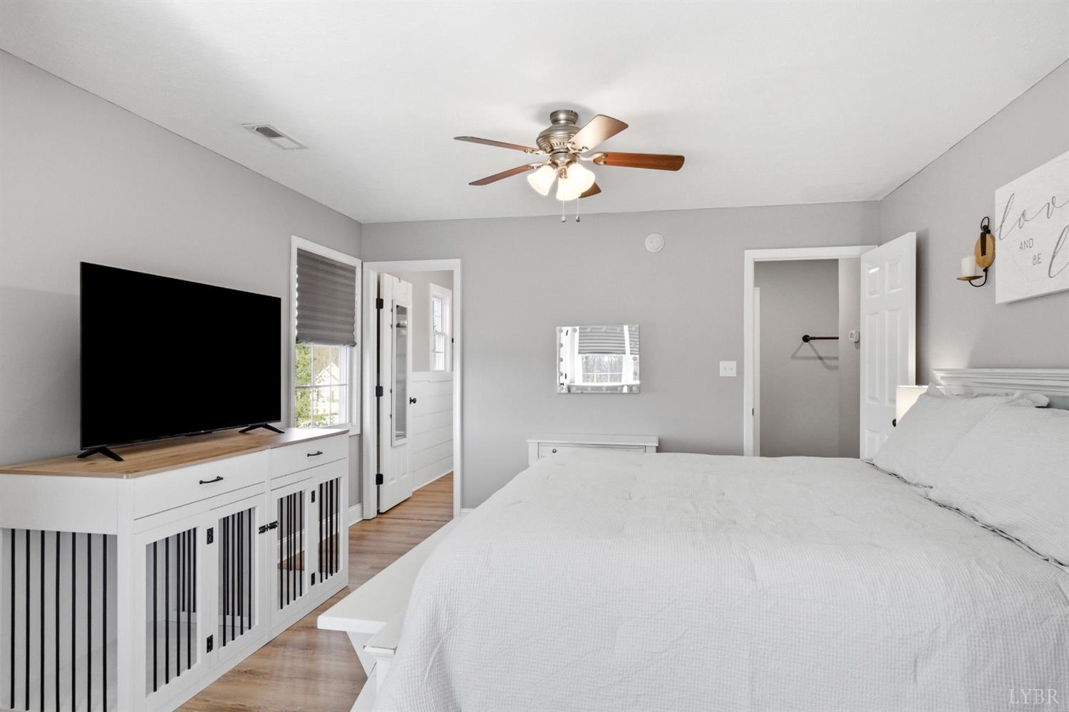 181 Armistead Lane Rustburg, VA 24588 - Photo 21 of 52 a bedroom with a flat screen tv and a ceiling fan