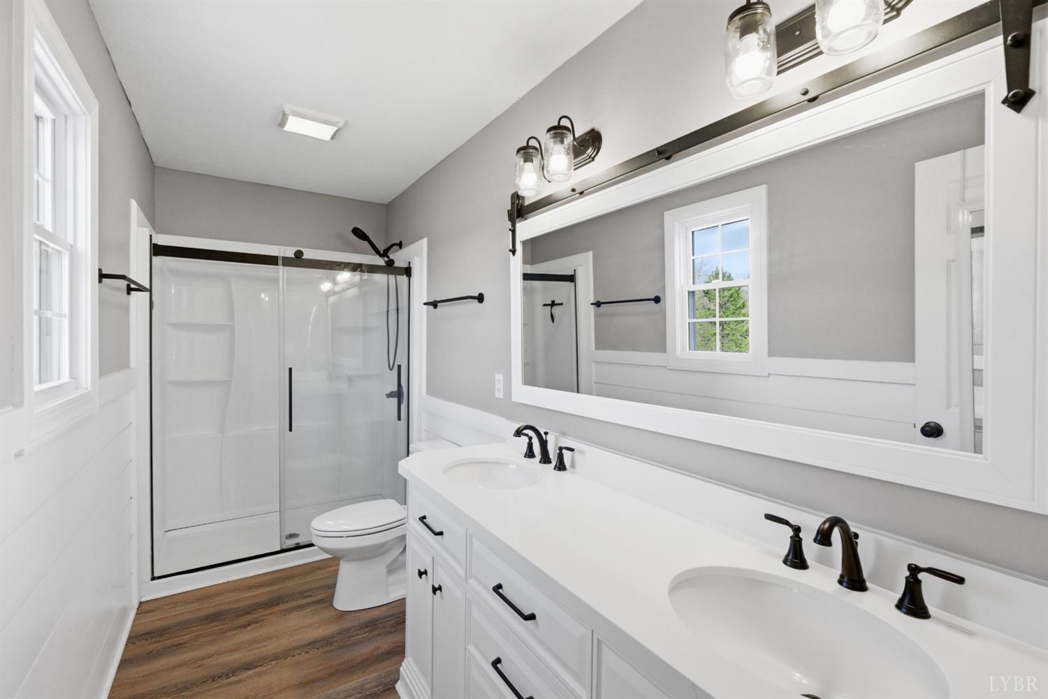 181 Armistead Lane Rustburg, VA 24588 - Photo 22 of 52 a spacious bathroom with double vanity sink a mirror and a shower