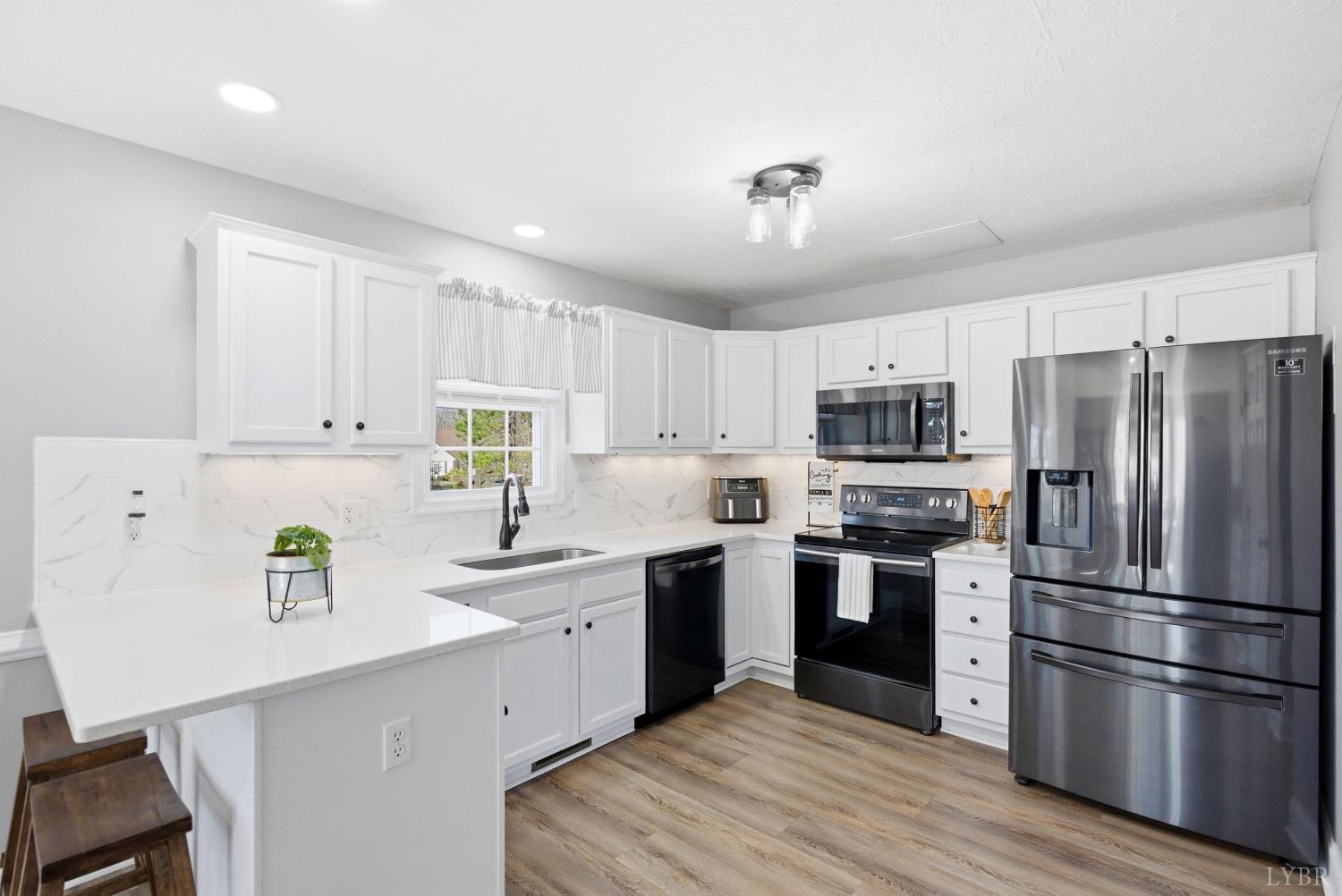 181 Armistead Lane Rustburg, VA 24588 - Photo 8 of 52 a kitchen with stainless steel appliances granite countertop a refrigerator sink and stove