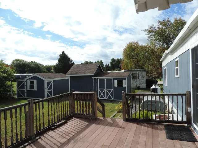 a view of a house with wooden deck