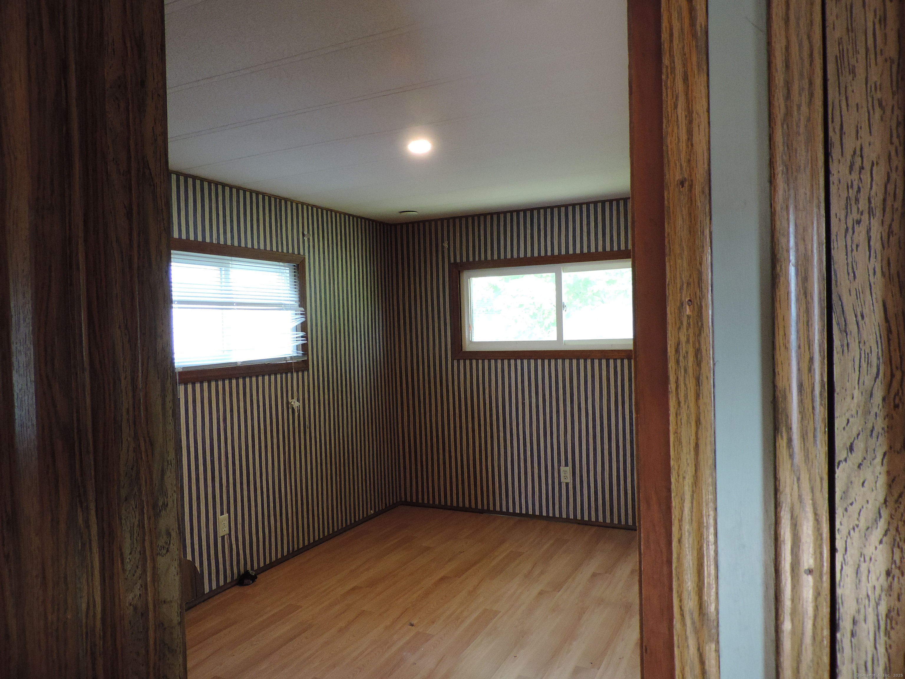 81 Parkway Drive Thompson, CT 06277 - Photo 6 of 7 a view of an empty room with wooden floor and a window