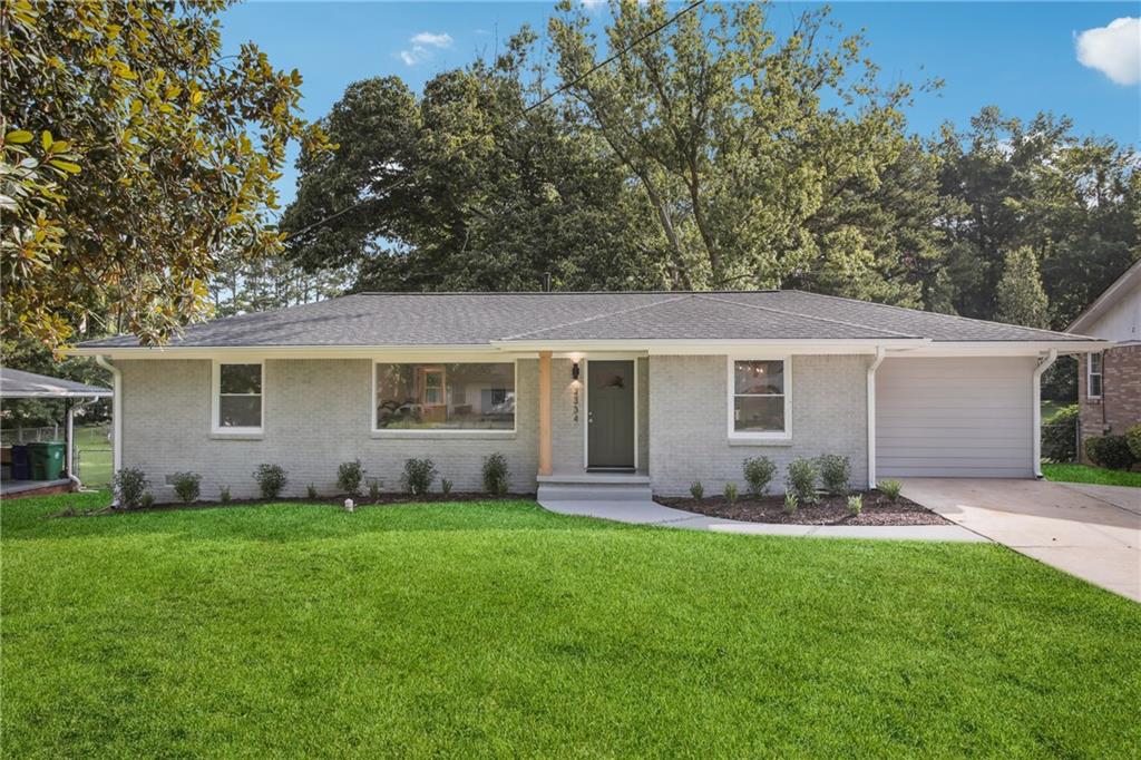 3334 Irish Lane Decatur, GA 30032 - Photo 1 of 1 front view of a house with a yard and trees