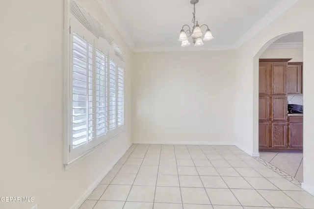 a large kitchen with stainless steel appliances granite countertop a refrigerator and a stove