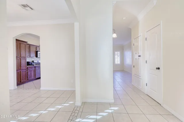 an empty room with kitchen and window