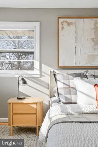 a bed sitting in a bedroom next to a window
