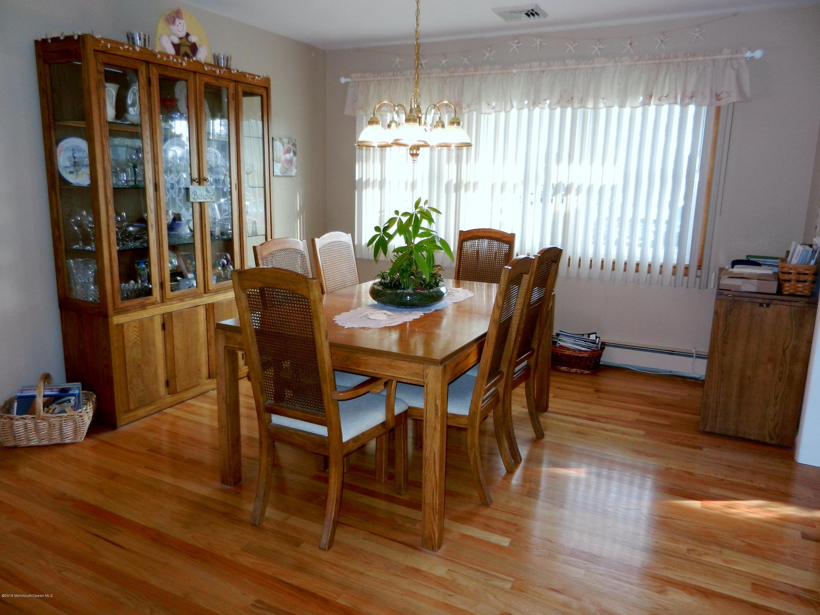 158 Cliff Road Brick, NJ 08724 - Photo 12 of 25 a view of a dining room with furniture window and wooden floor