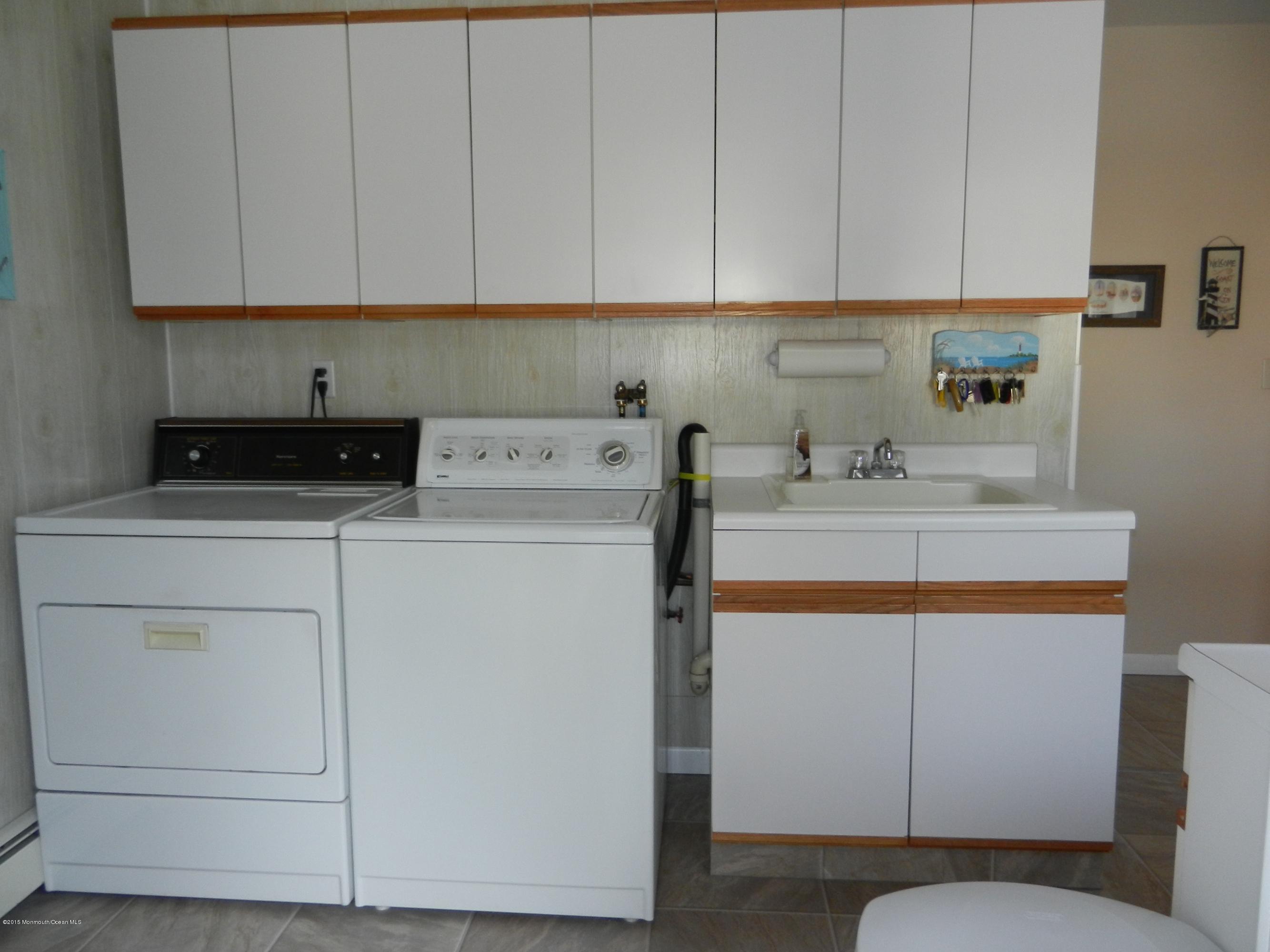 158 Cliff Road Brick, NJ 08724 - Photo 19 of 25 a utility room with cabinets washer and dryer