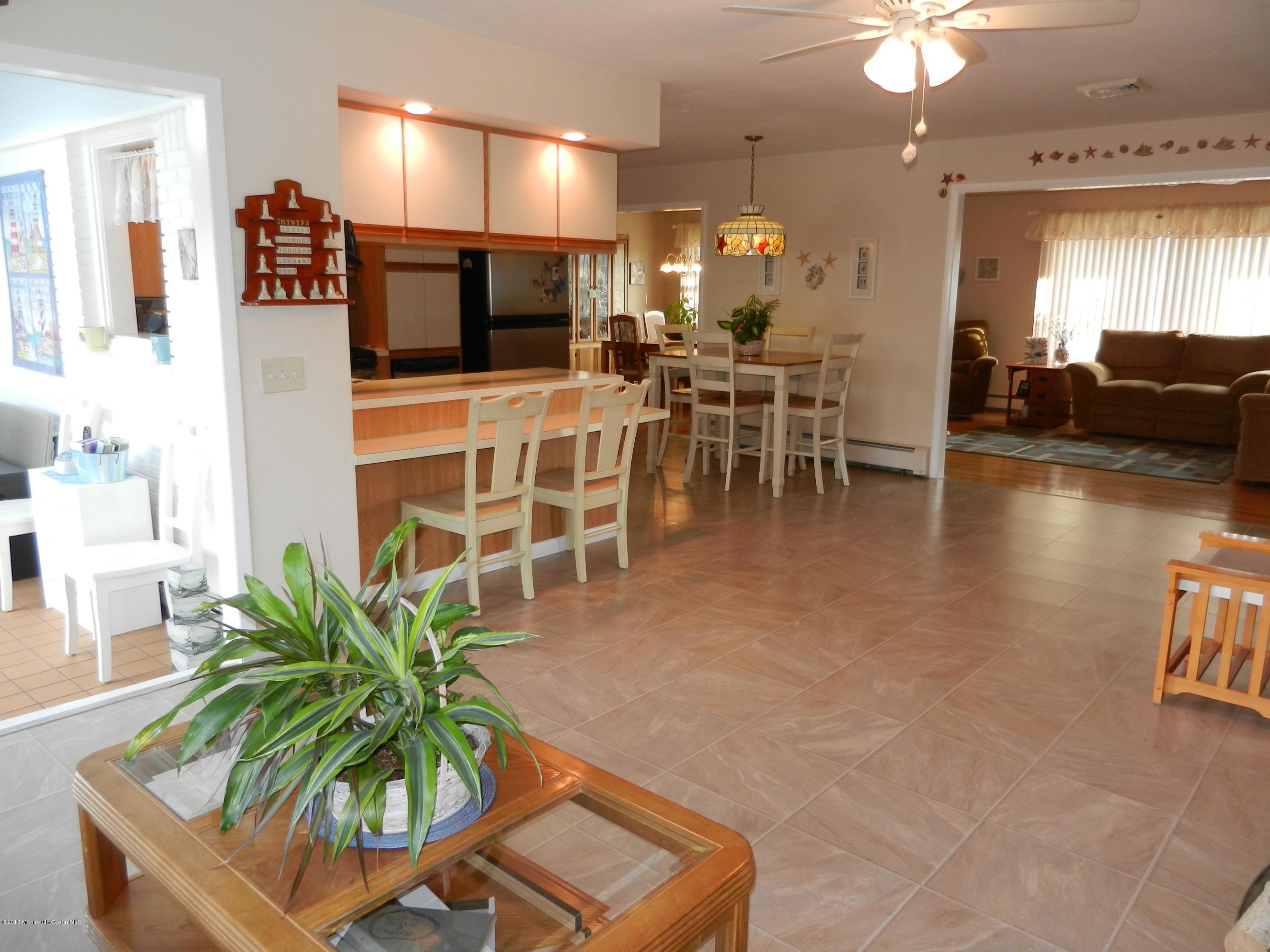 158 Cliff Road Brick, NJ 08724 - Photo 9 of 25 a living room with furniture a flat screen tv and kitchen view