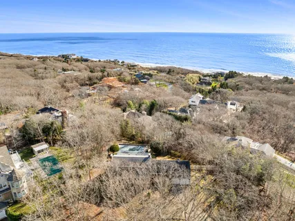 an aerial view of house with beach and ocean view