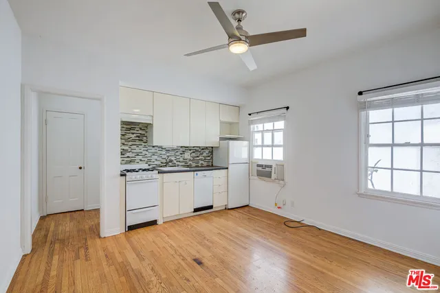 a kitchen with granite countertop a sink and a refrigerator