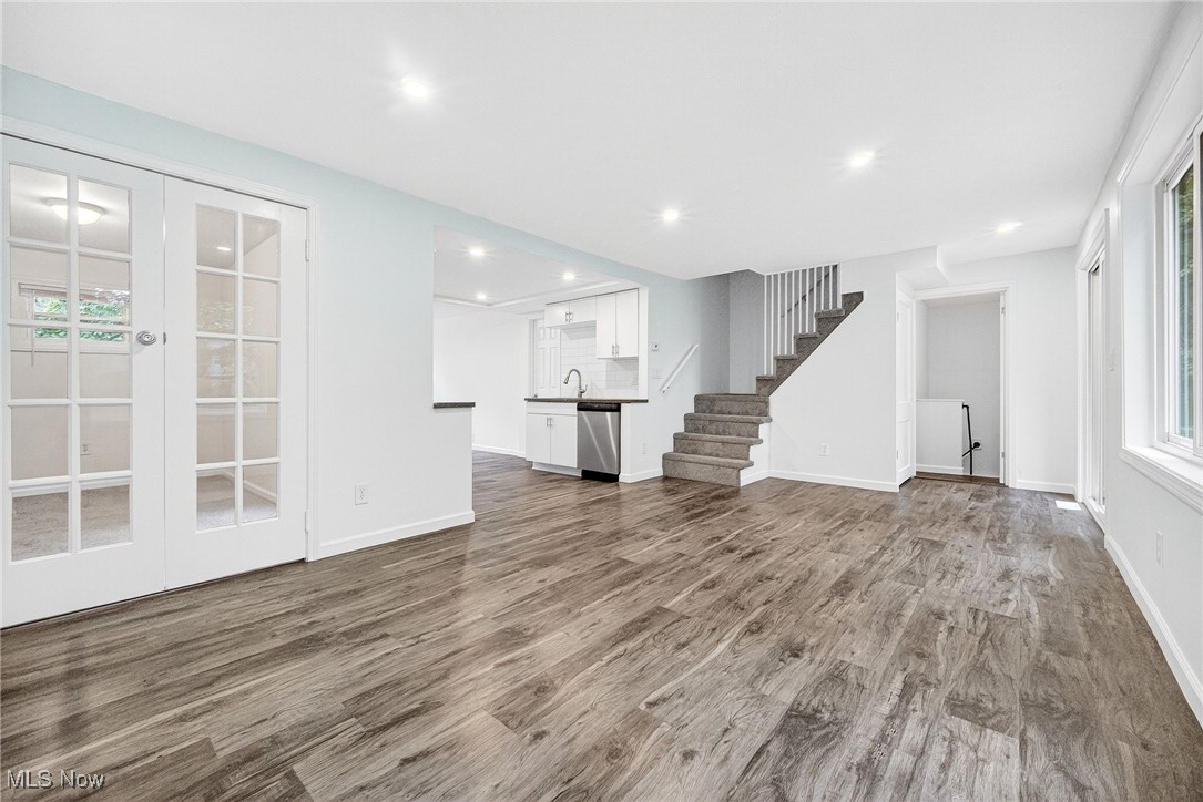 4669 Liberty Road Cleveland, OH 44121 - Photo 6 of 30 Unfurnished living room with healthy amount of natural light, wood finished floors, stairs, french doors, and recessed lighting