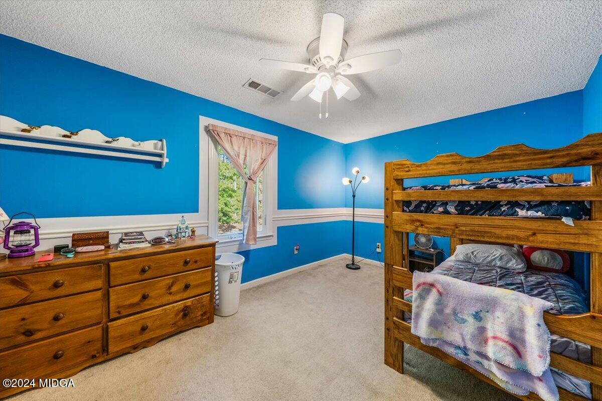 2559 Reedy Creek Road Forsyth, GA 31029 - Photo 12 of 20 a bedroom with a bed and a dresser in it