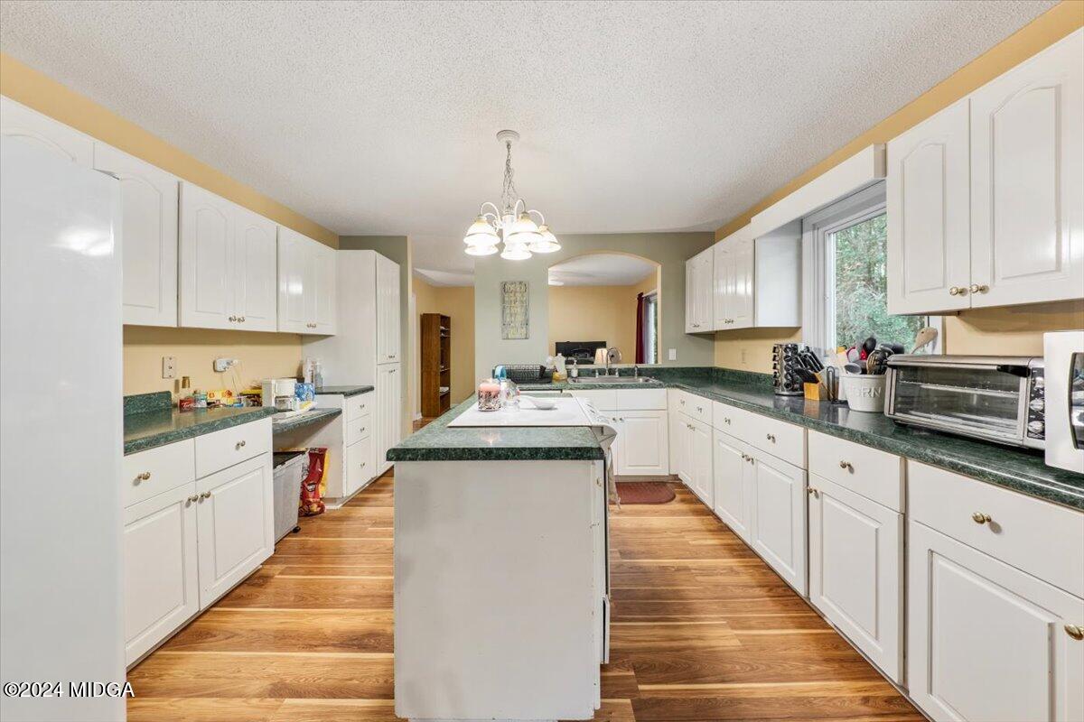 2559 Reedy Creek Road Forsyth, GA 31029 - Photo 6 of 20 a large kitchen with cabinets
