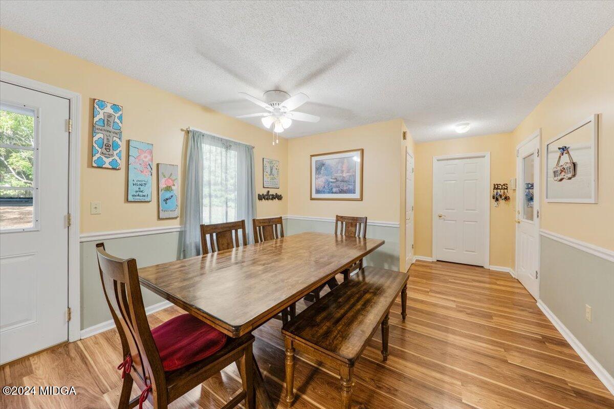 2559 Reedy Creek Road Forsyth, GA 31029 - Photo 7 of 20 a view of a dining room with furniture and wooden floor