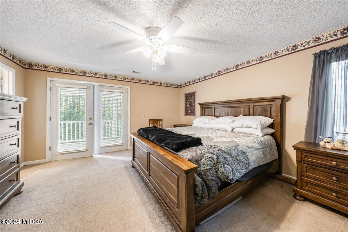 2559 Reedy Creek Road Forsyth, GA 31029 - Photo 9 of 20 a bedroom with a bed and a chandelier