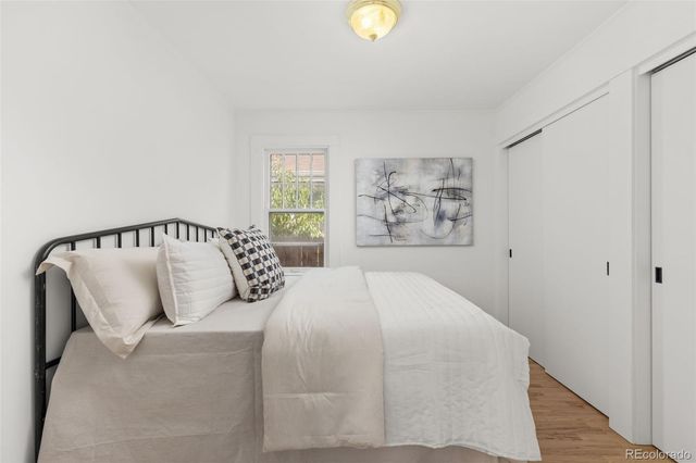 a bedroom with a large bed and a window