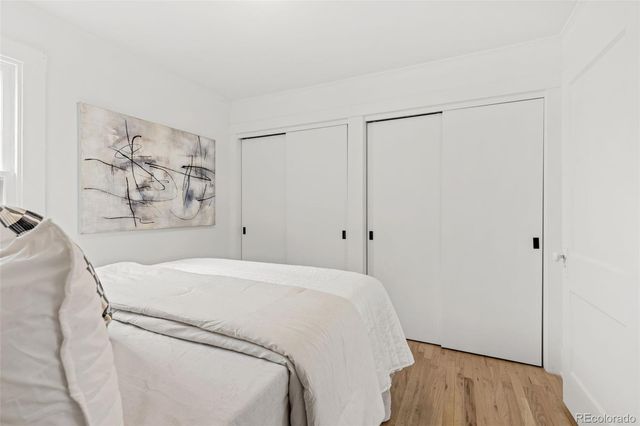 a room with a bed and a wooden floor