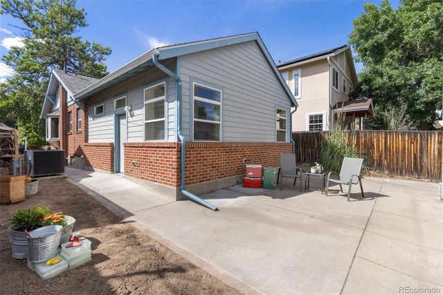 a view of a chair and tables in the patio