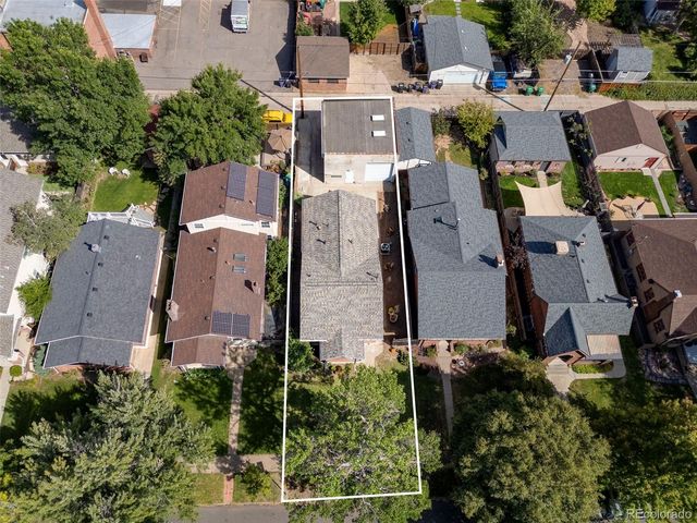 a view of a patio with table and chairs with wooden floor and fence
