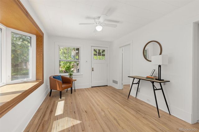 a work room with furniture and a large window