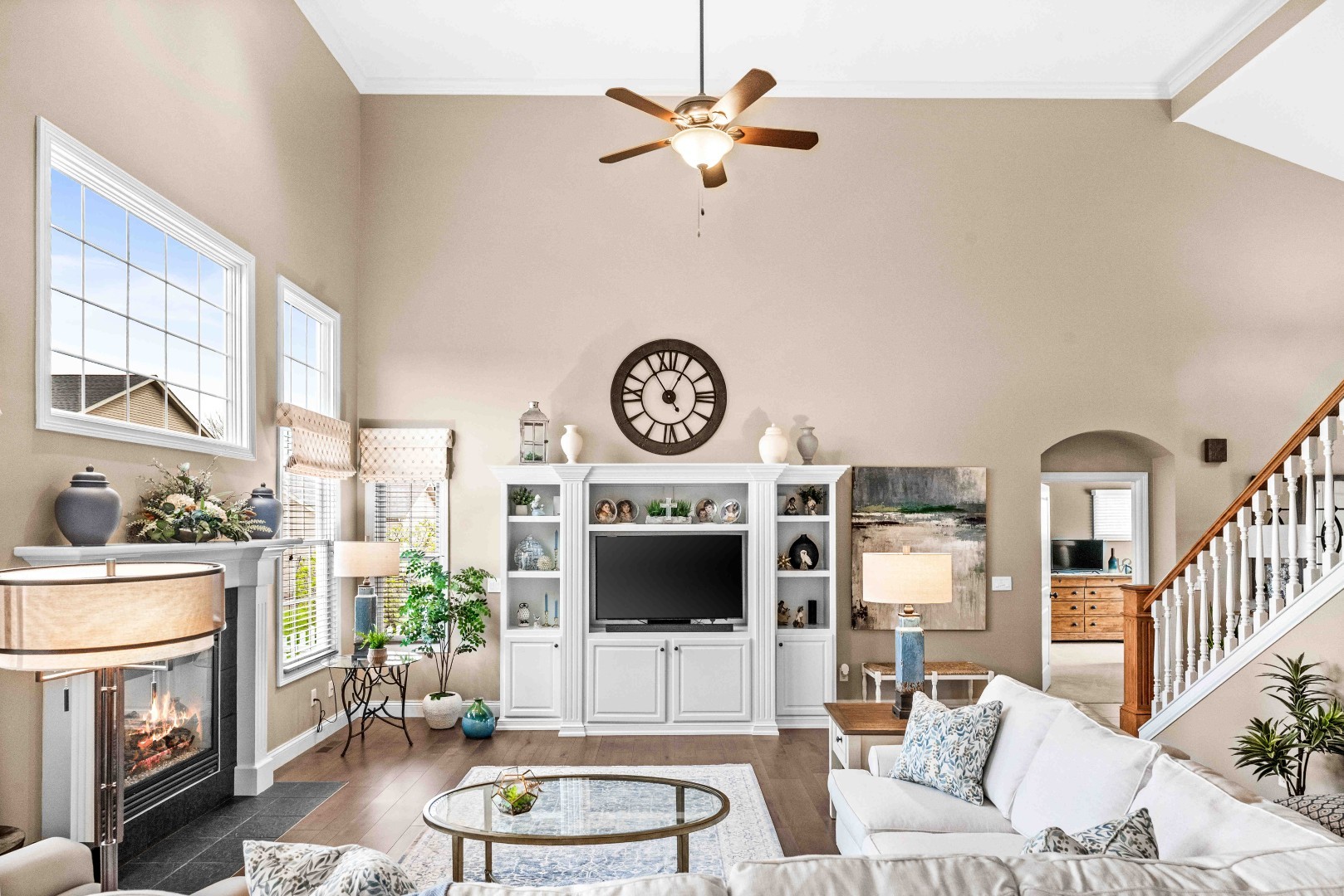 1048 Norway Court Normal, IL 61761 - Photo 16 of 83 a living room with furniture a fireplace a clock and a flat screen tv