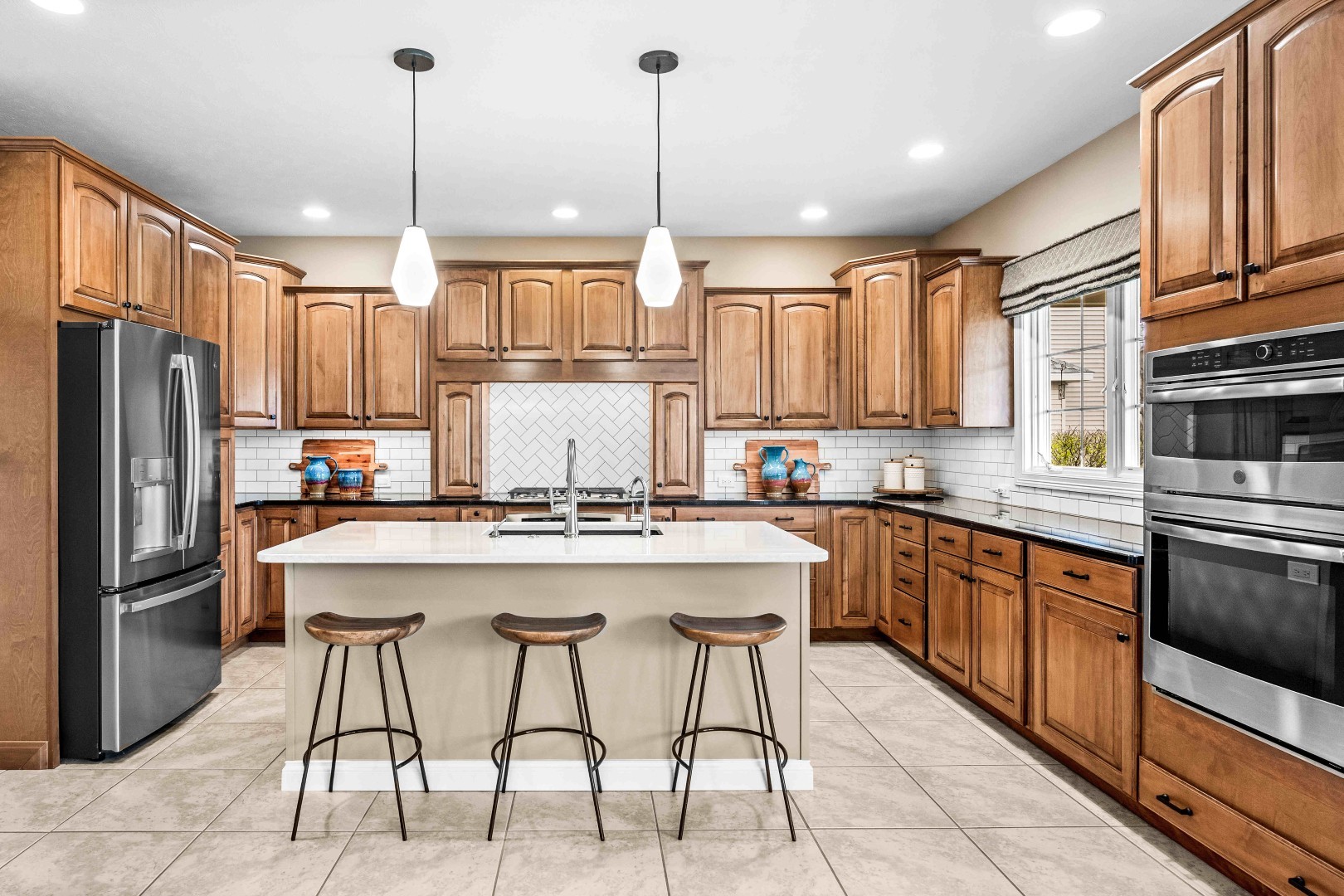 1048 Norway Court Normal, IL 61761 - Photo 19 of 83 a kitchen with stainless steel appliances granite countertop a stove a sink a refrigerator and chairs