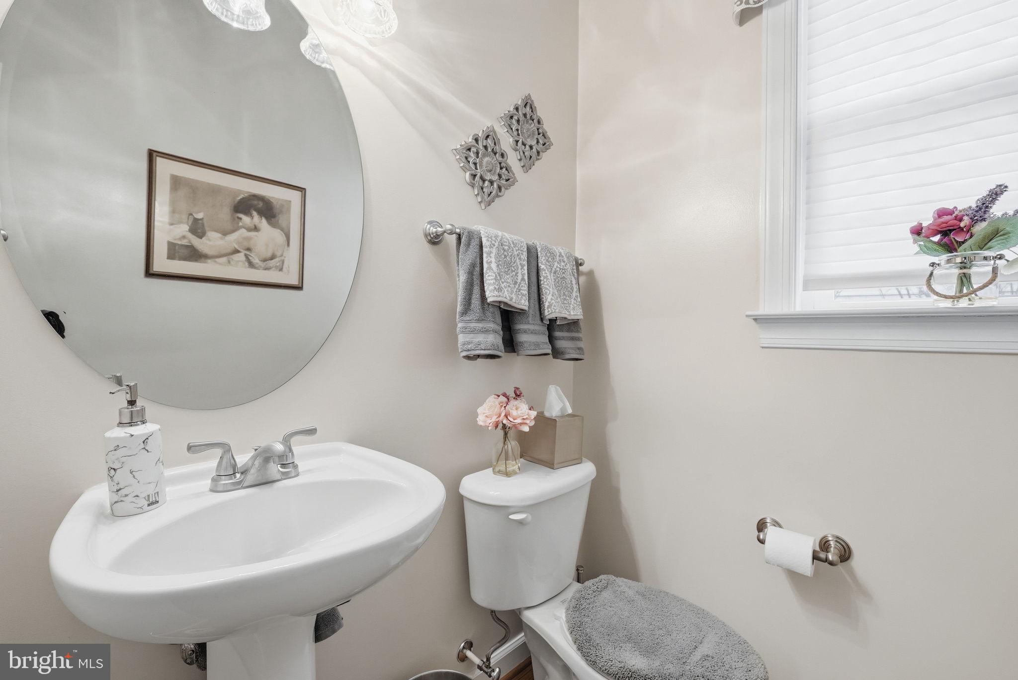 7820 Rose Garden Lane Springfield, VA 22153 - Photo 13 of 65 a bathroom with a sink mirror and toilet