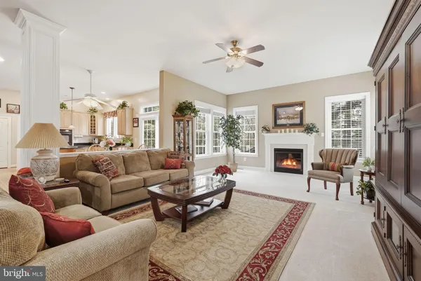 a living room with furniture wooden floor and a fireplace