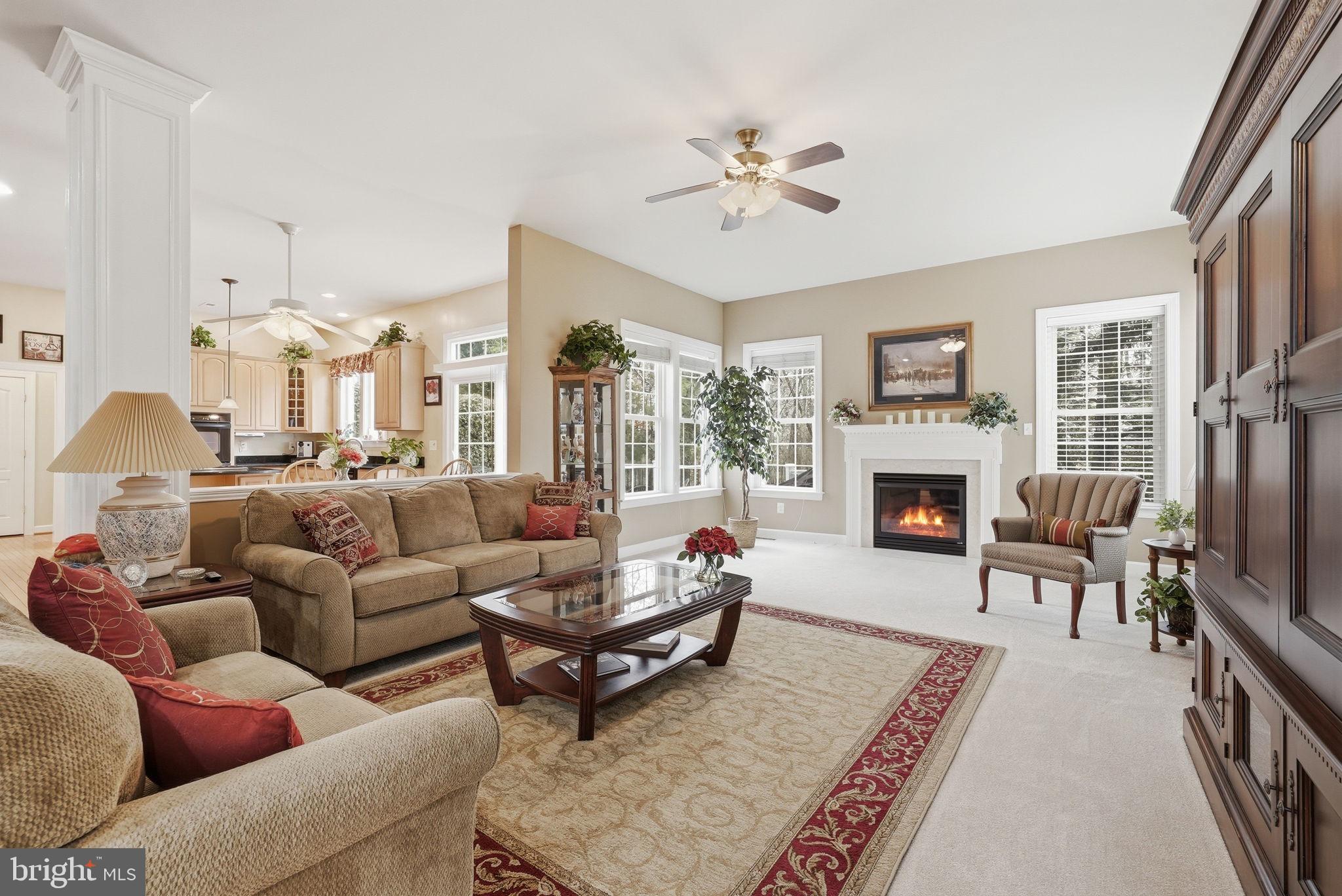 7820 Rose Garden Lane Springfield, VA 22153 - Photo 15 of 65 a living room with furniture a fireplace and a table