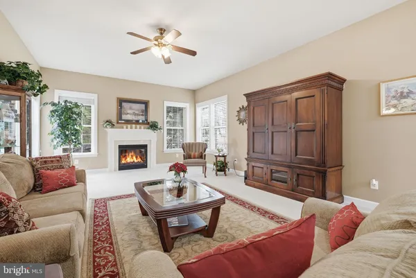 a living room with furniture rug and a chandelier