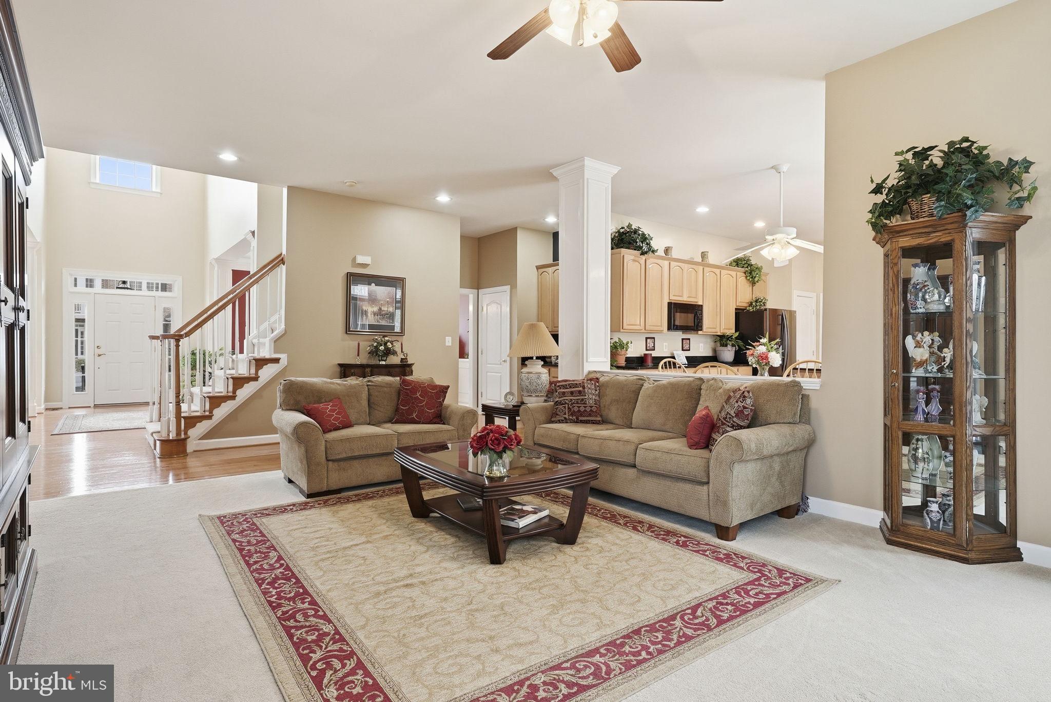 7820 Rose Garden Lane Springfield, VA 22153 - Photo 18 of 65 a living room with furniture rug and a chandelier