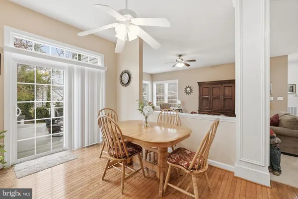 a kitchen with granite countertop a stove a sink and dishwasher wooden cabinets with wooden floor