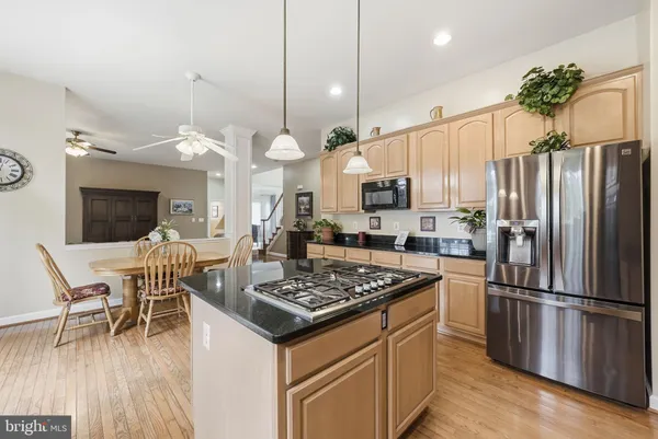a kitchen with granite countertop white cabinets and stainless steel appliances