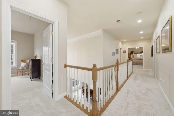 a spacious bedroom with a bed and a chandelier