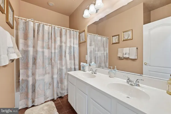 a living room with furniture a flat screen tv and a book shelf