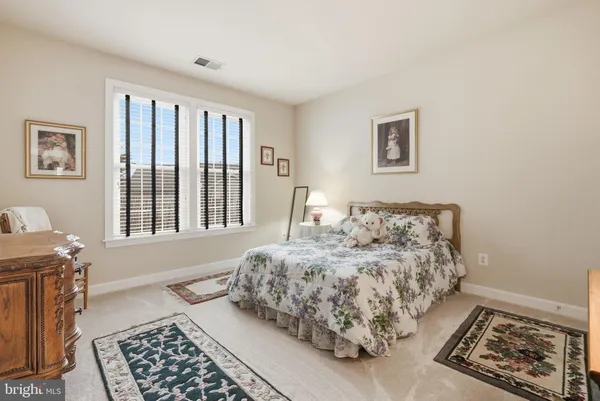 a living room with furniture and a book shelf