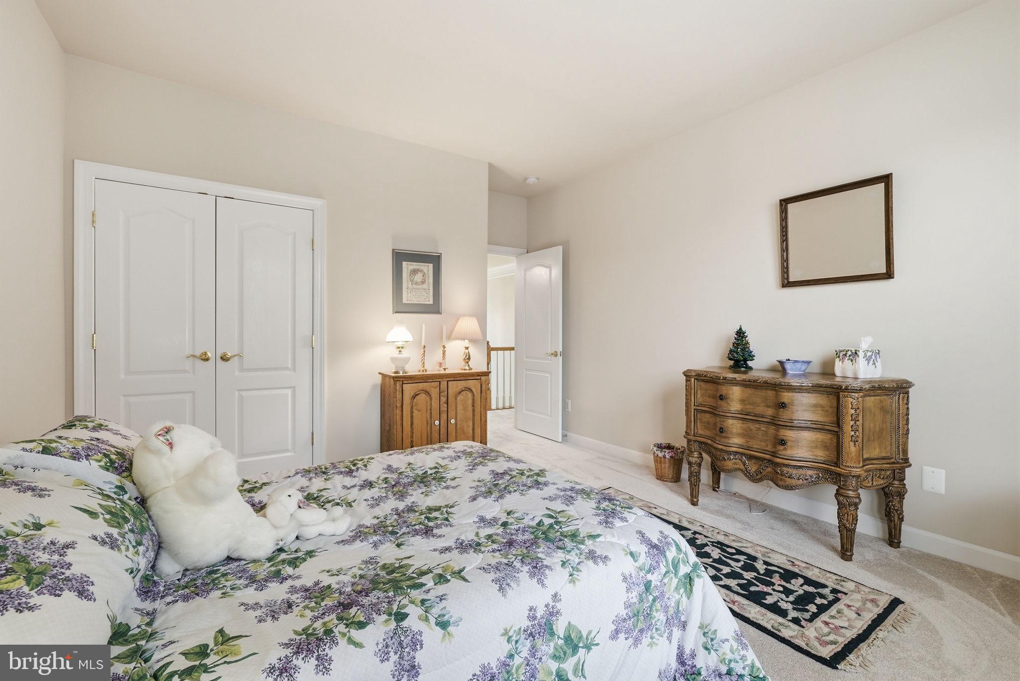 7820 Rose Garden Lane Springfield, VA 22153 - Photo 32 of 65 a bedroom with a bed and a table in it