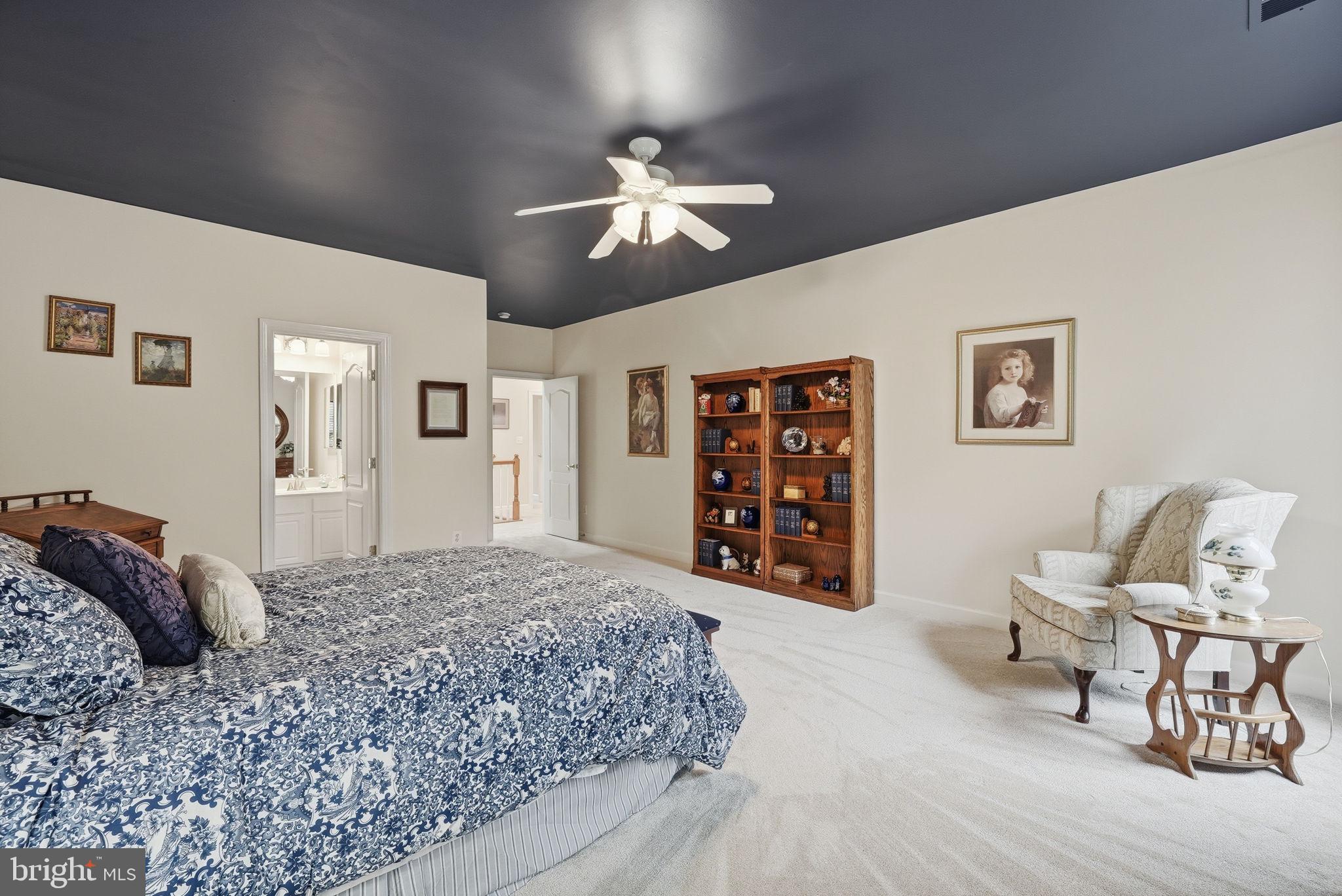 7820 Rose Garden Lane Springfield, VA 22153 - Photo 37 of 65 a spacious bedroom with a bed and a chandelier