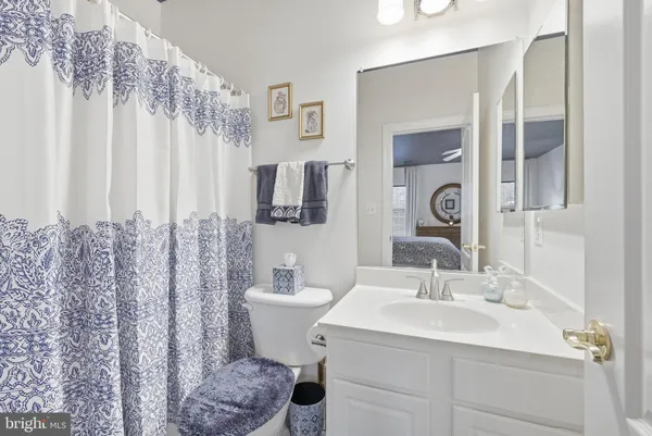 a spacious bathroom with a tub sink and mirror