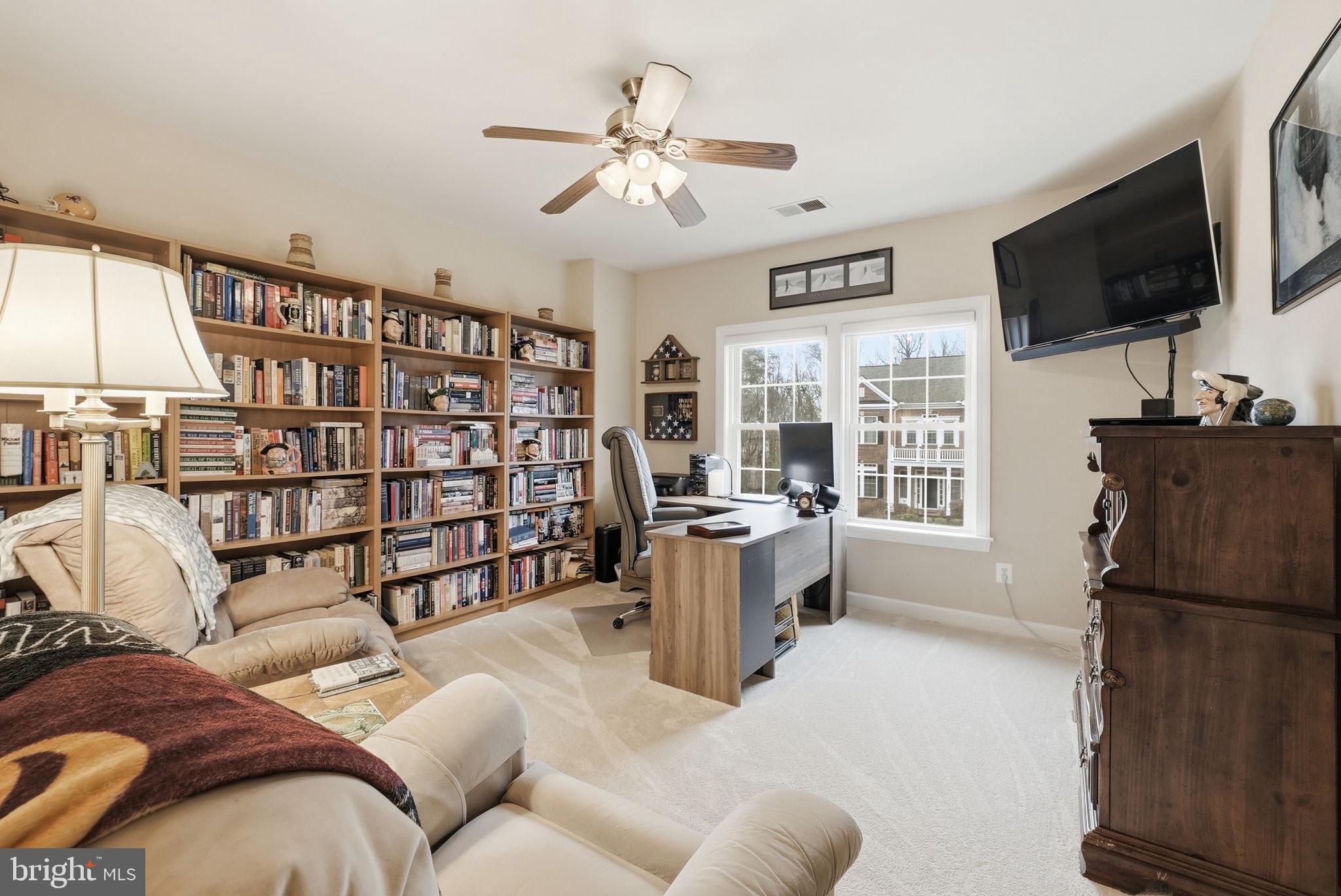 7820 Rose Garden Lane Springfield, VA 22153 - Photo 39 of 65 a living room with furniture a flat screen tv and a book shelf