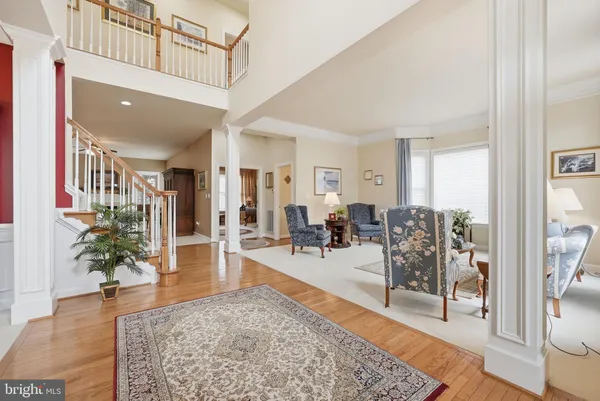 a living room with furniture potted plant and wooden floor