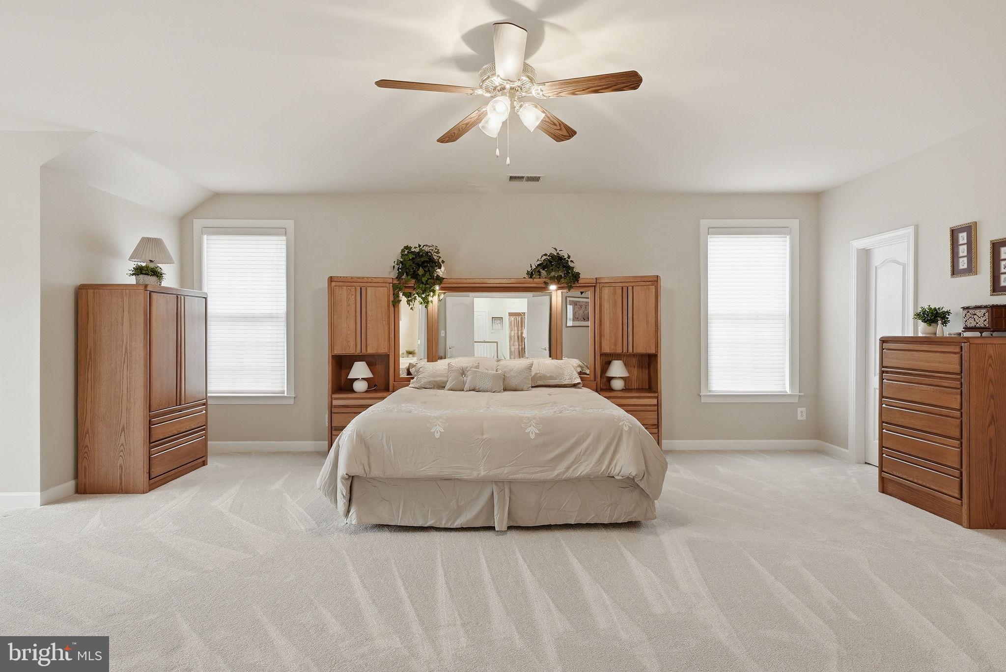 7820 Rose Garden Lane Springfield, VA 22153 - Photo 41 of 65 a bedroom with a bed and a chandelier